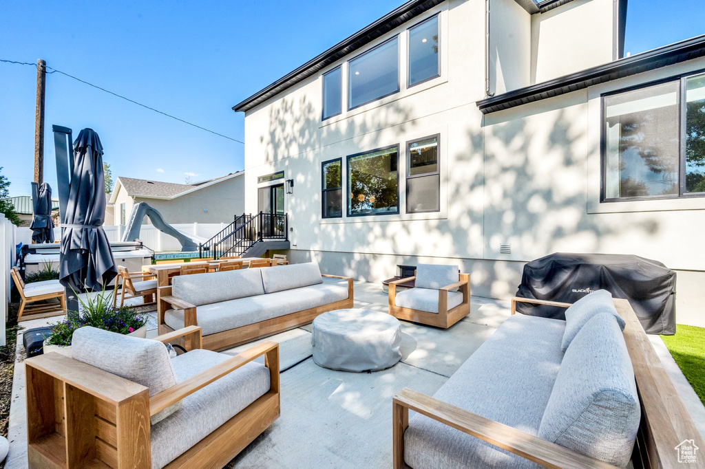 View of patio with an outdoor hangout area