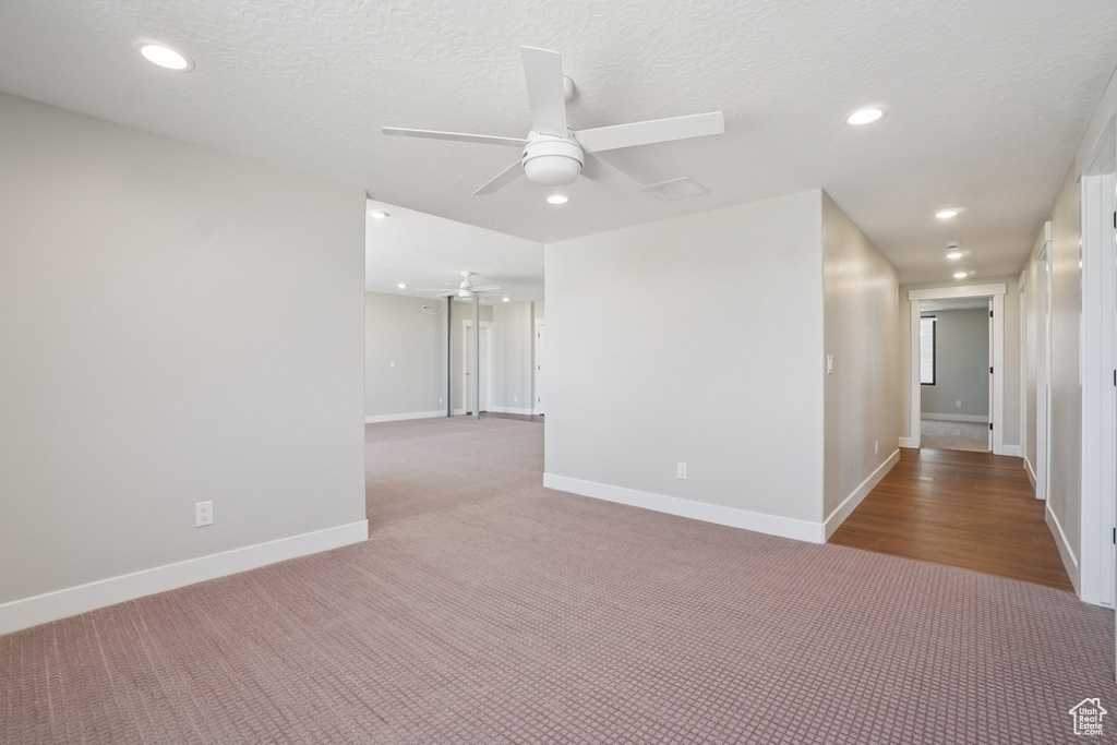 Unfurnished room featuring ceiling fan, carpet flooring, recessed lighting, and baseboards