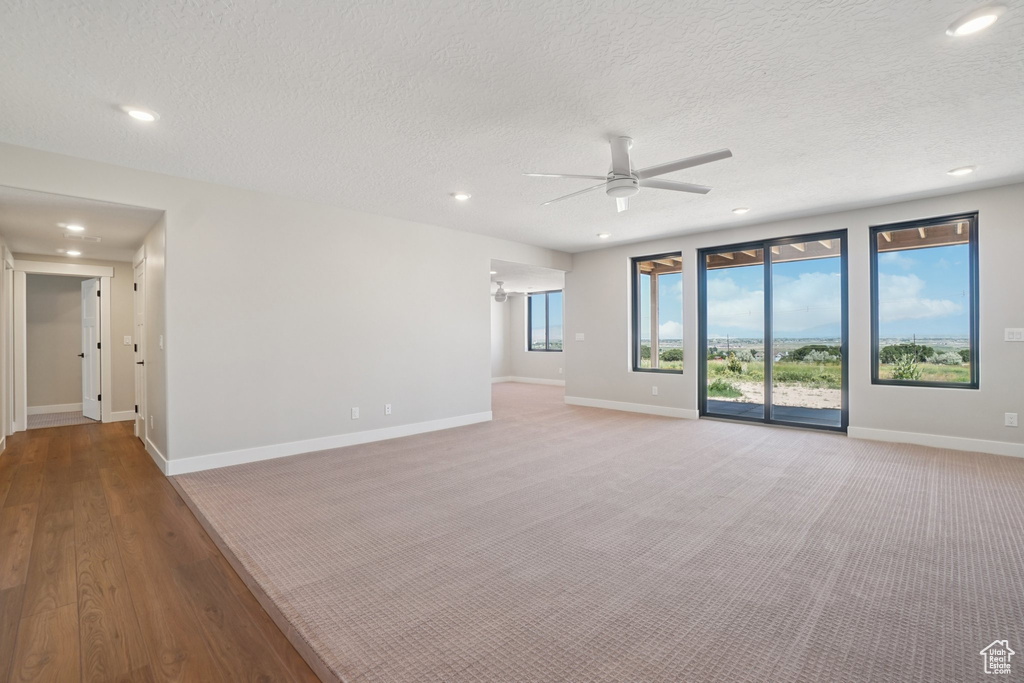 Unfurnished room featuring a ceiling fan, recessed lighting, baseboards, a textured ceiling, and carpet flooring