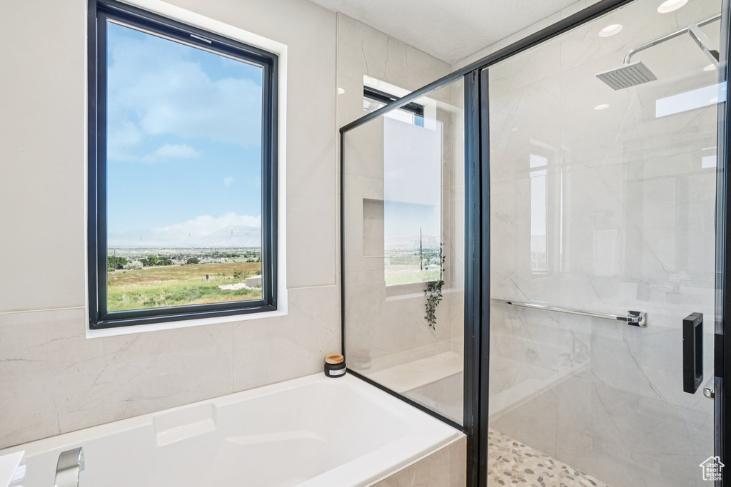 Bathroom with a garden tub and a stall shower