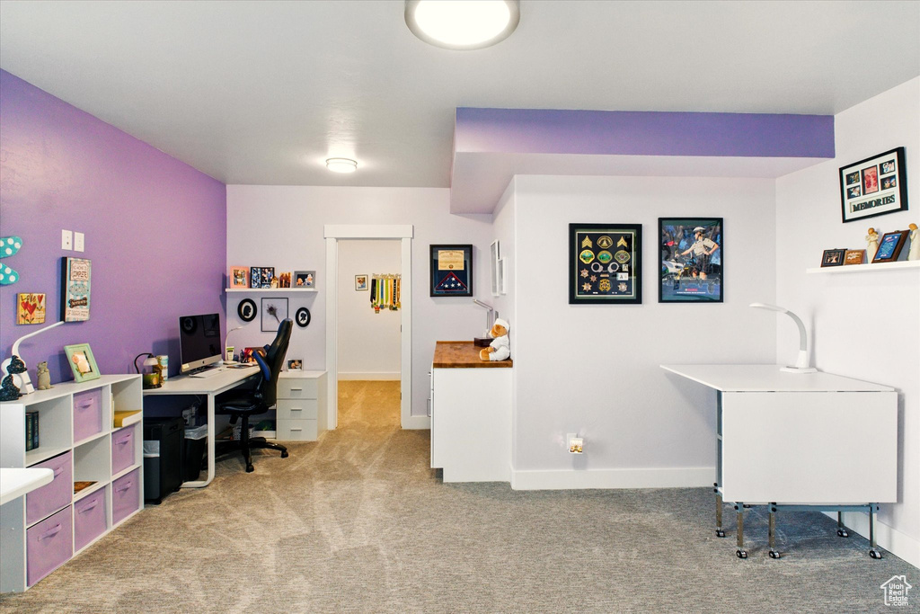 Home office featuring light carpet and baseboards