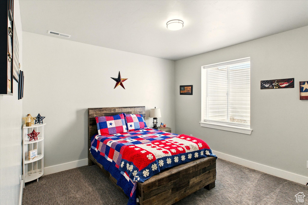 Carpeted bedroom with baseboards