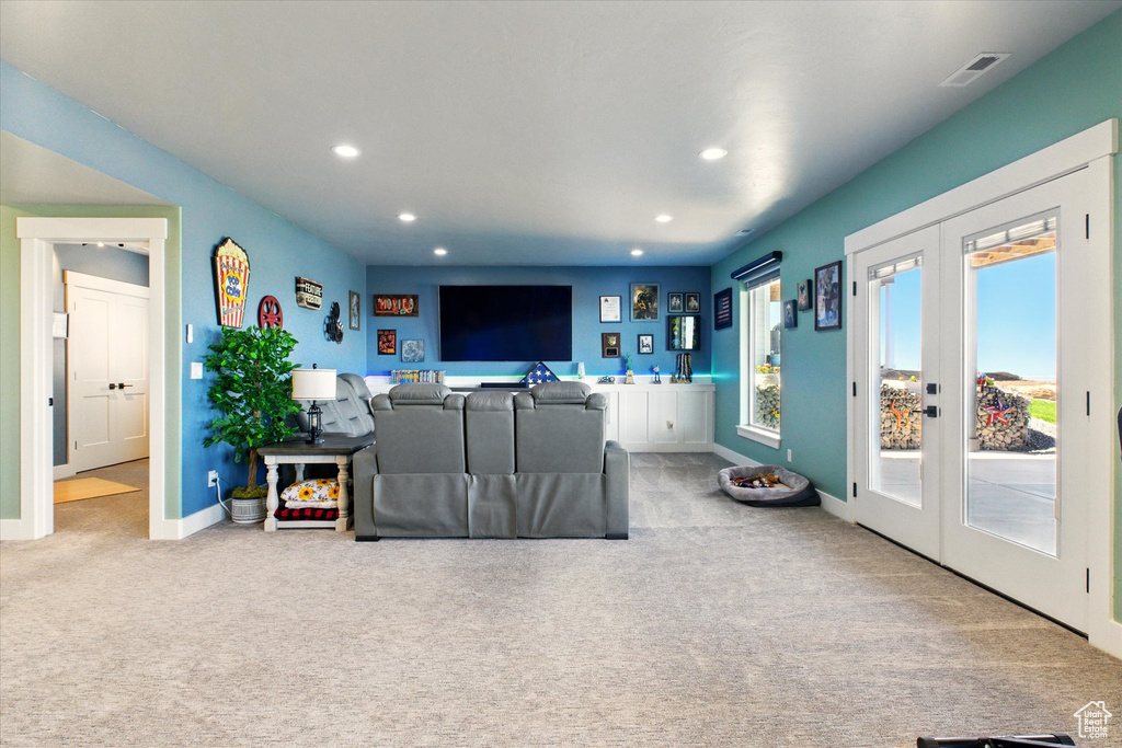 Carpeted living room featuring french doors, recessed lighting, and baseboards