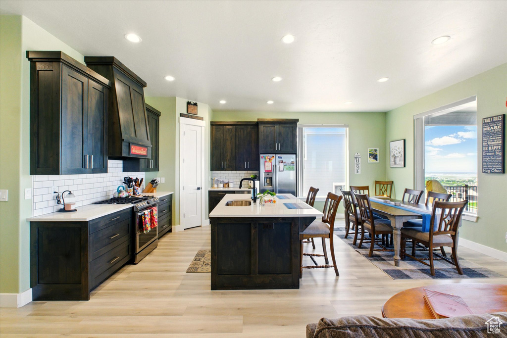 Kitchen with stainless steel appliances, a sink, healthy amount of natural light, light countertops, and recessed lighting