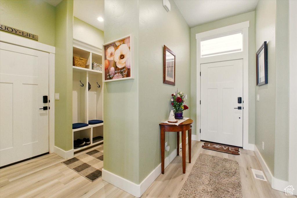 Foyer entrance featuring light wood-style floors and baseboards