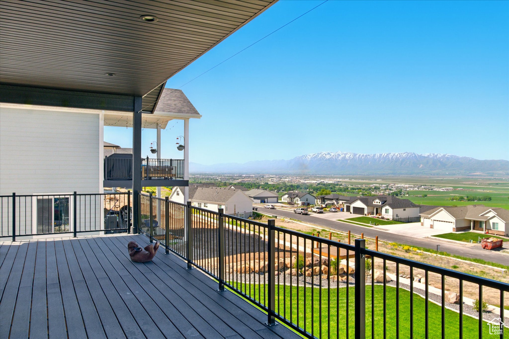 Wooden deck with a residential view and a mountain view