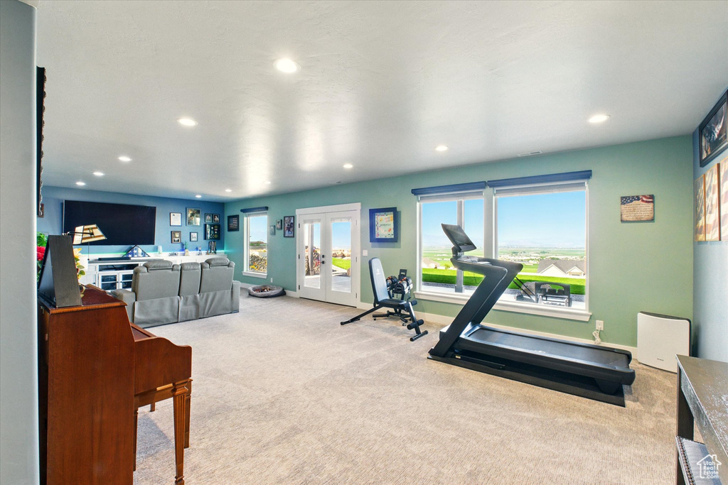 Exercise area featuring carpet, french doors, recessed lighting, and baseboards