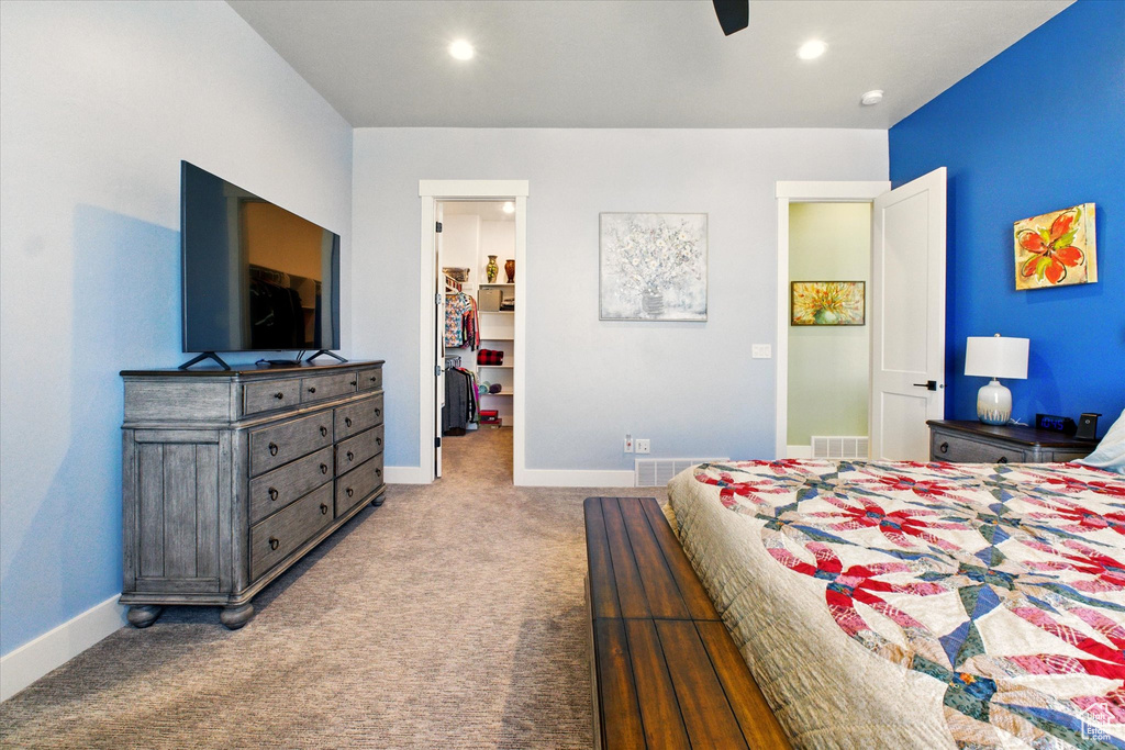 Carpeted bedroom featuring a spacious closet, baseboards, recessed lighting, and ceiling fan