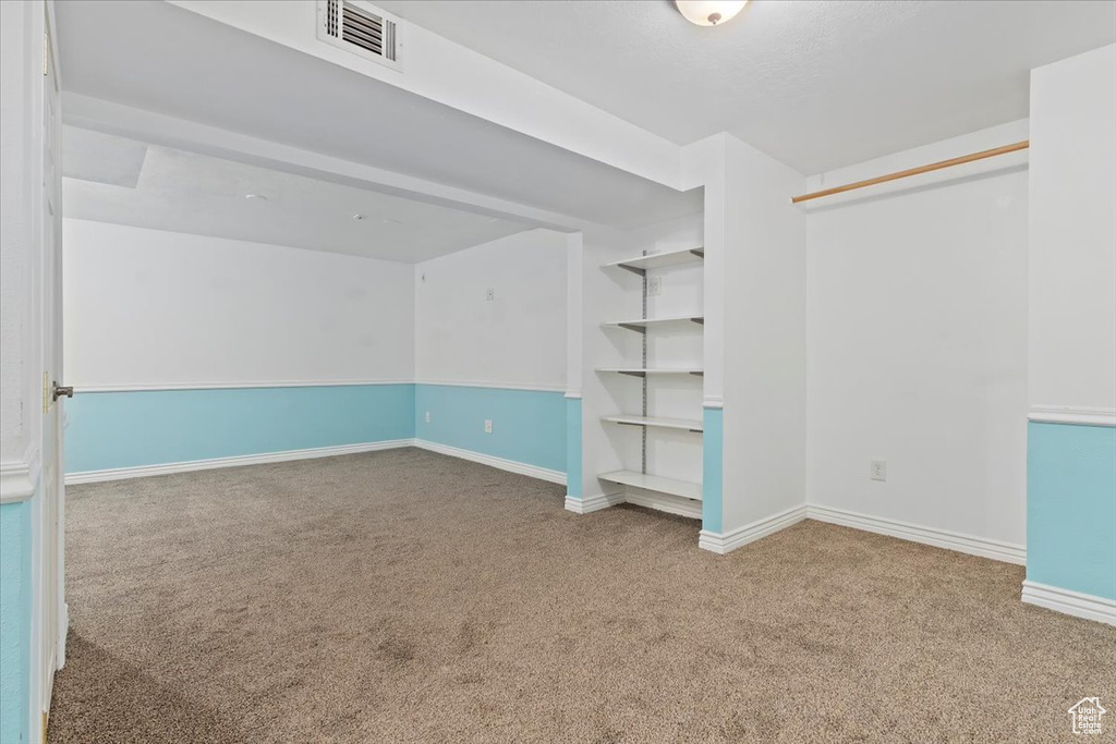 Carpeted empty room featuring baseboards