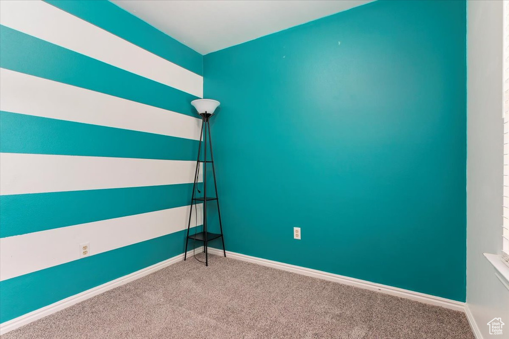 Unfurnished bedroom featuring carpet floors and baseboards