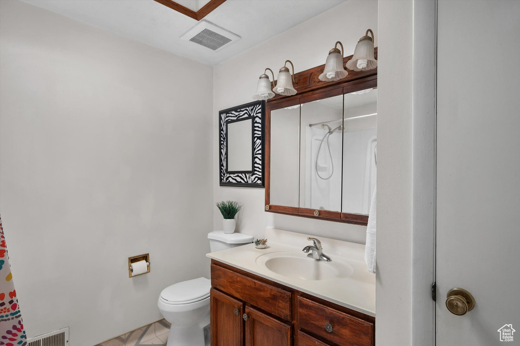 Full bathroom with vanity, toilet, curtained shower, and tile patterned flooring