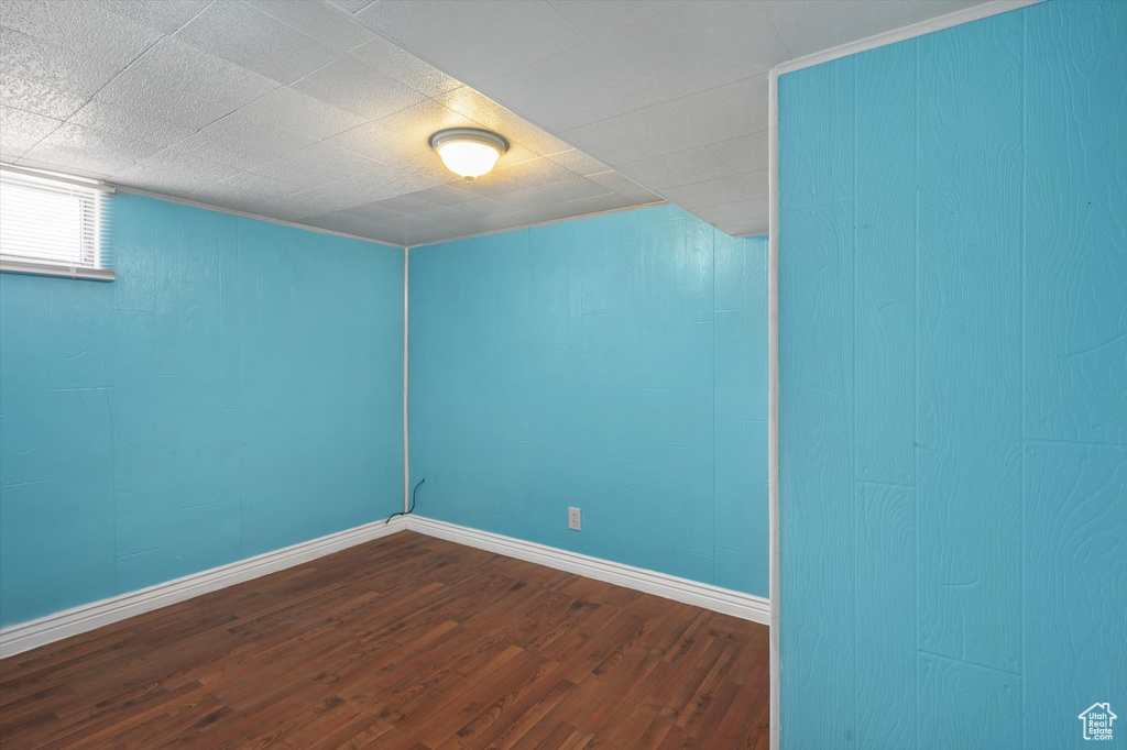 Empty room with dark wood finished floors and baseboards