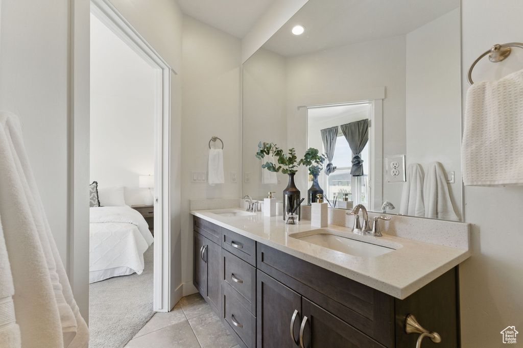 Bathroom featuring double vanity, connected bathroom, tile patterned flooring, and recessed lighting