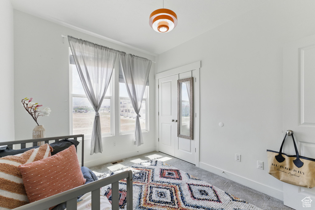 Foyer featuring carpet and baseboards