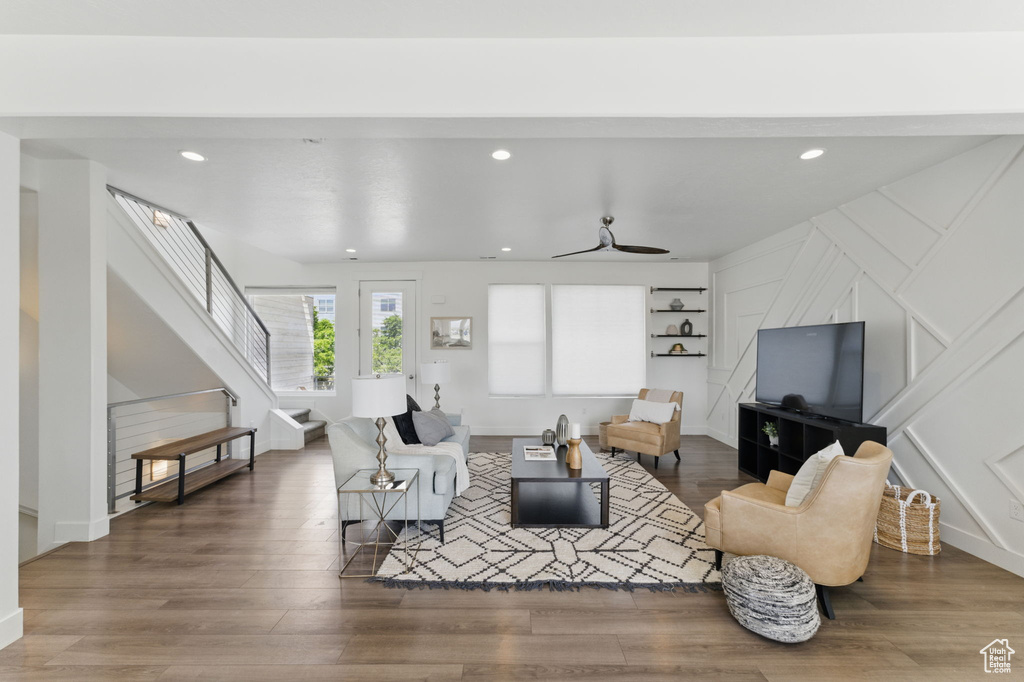 Living area with stairs, wood finished floors, recessed lighting, baseboards, and ceiling fan