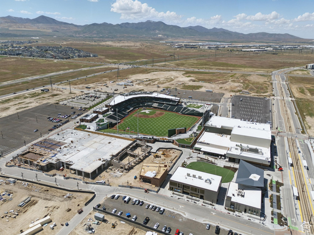 Aerial view of property and surrounding area with a mountain backdrop
