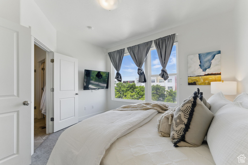 Tiled bedroom featuring carpet flooring