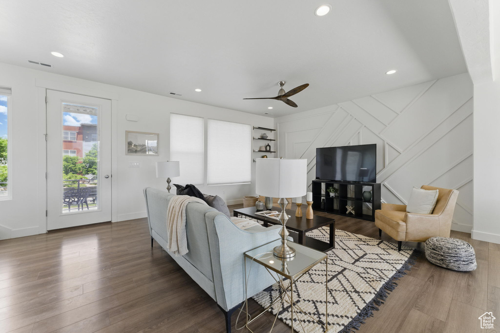 Living area with a ceiling fan, wood finished floors, recessed lighting, and baseboards