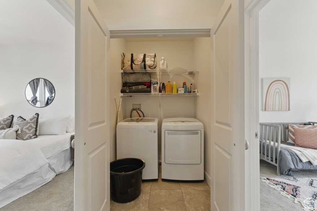 Laundry area with washer and dryer and tile patterned floors