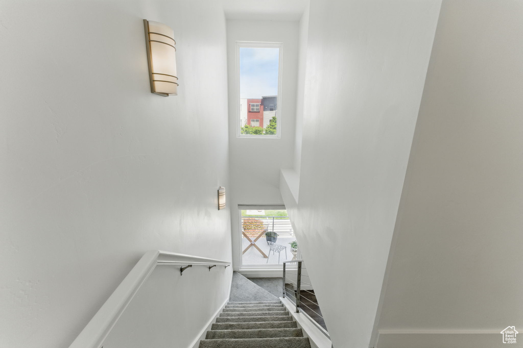 Stairway with a high ceiling and baseboards