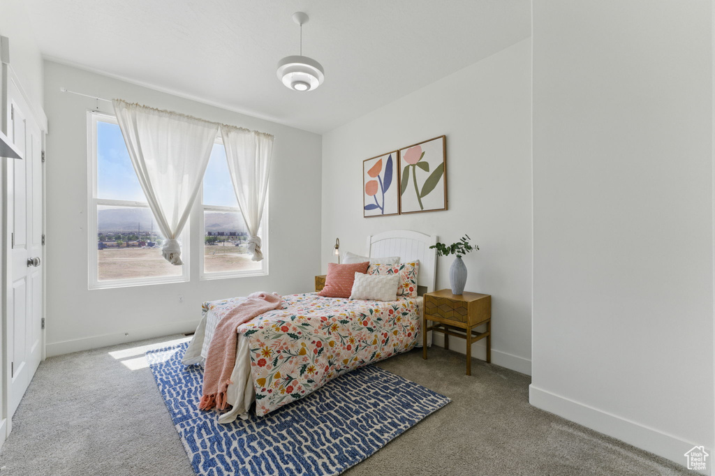 Carpeted bedroom with baseboards