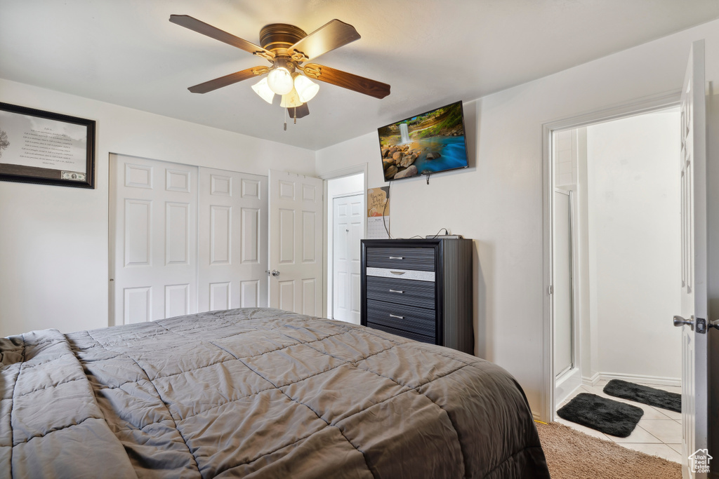 Bedroom featuring tile patterned floors, a ceiling fan, a closet, and baseboards