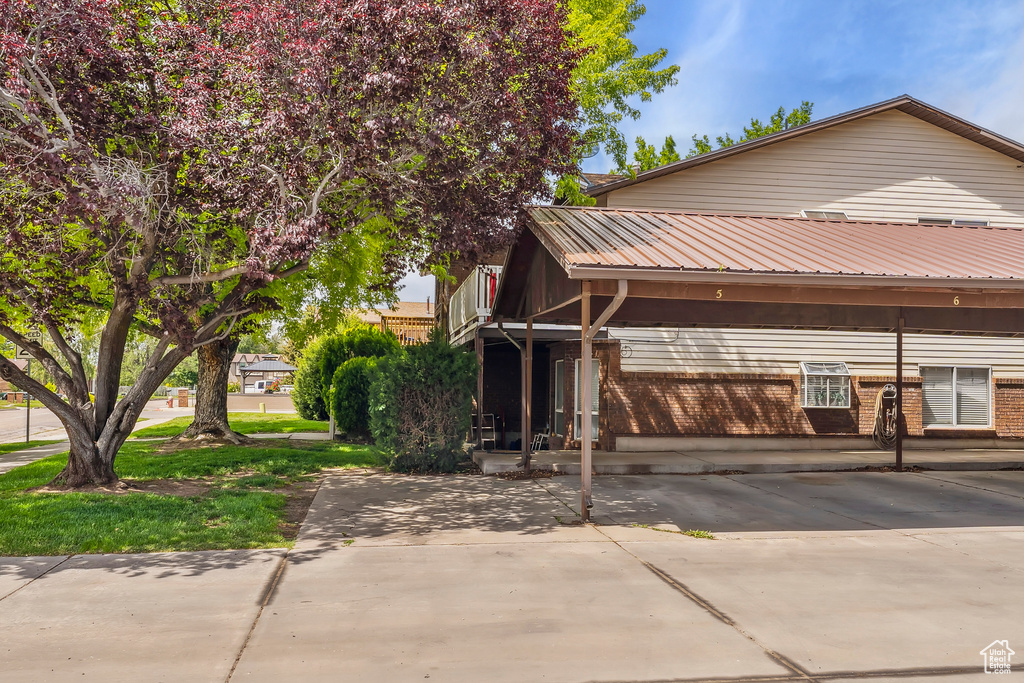 View of front of home featuring brick siding and metal roof