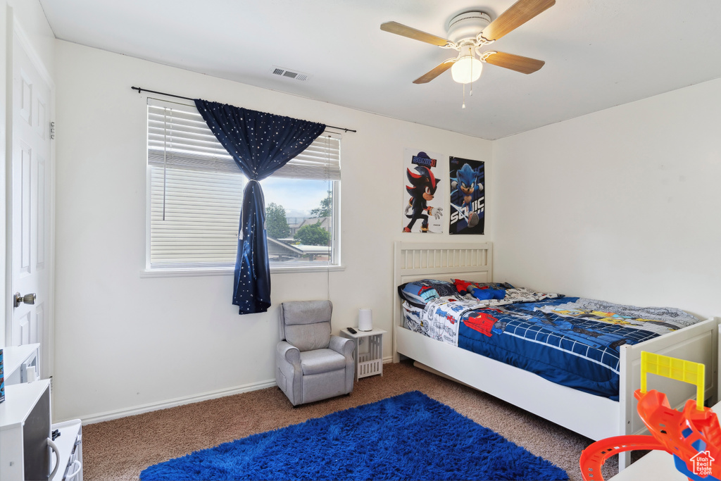 Bedroom featuring carpet, baseboards, and ceiling fan