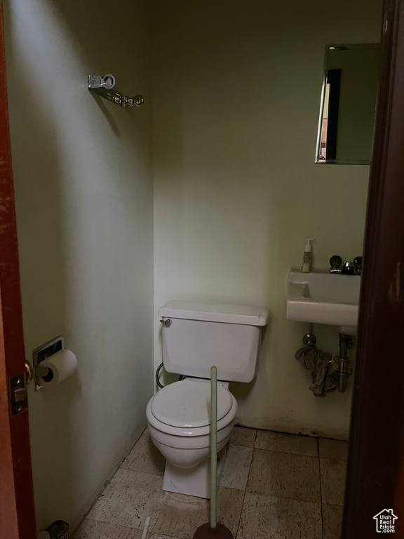 Half bathroom featuring toilet and a sink