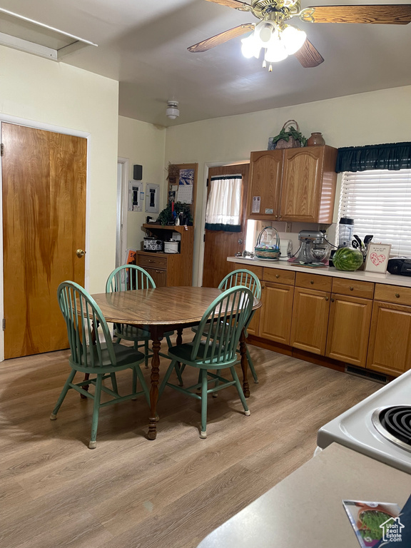 Dining room with light wood-type flooring and a ceiling fan
