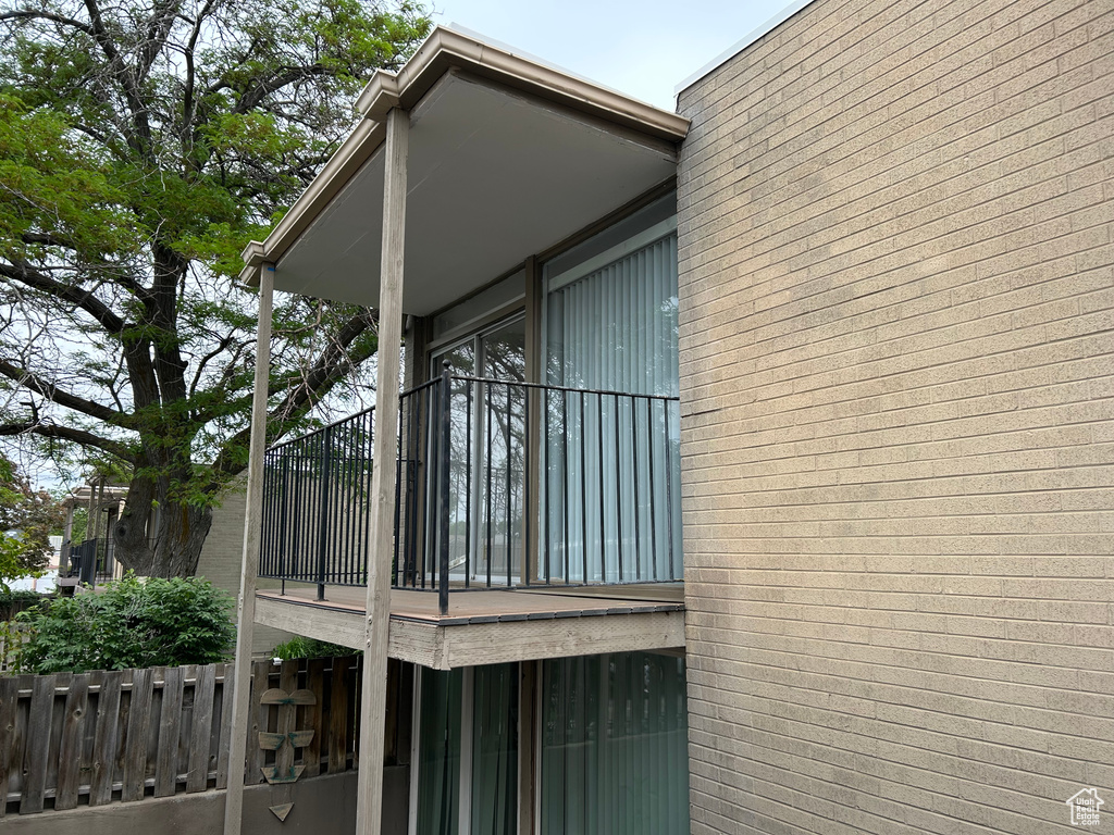 View of side of property with a balcony