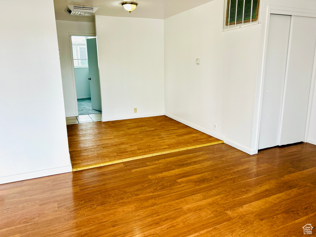 Unfurnished room featuring wood finished floors and baseboards