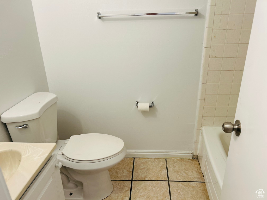 Full bathroom featuring tile patterned floors, toilet, vanity, and baseboards
