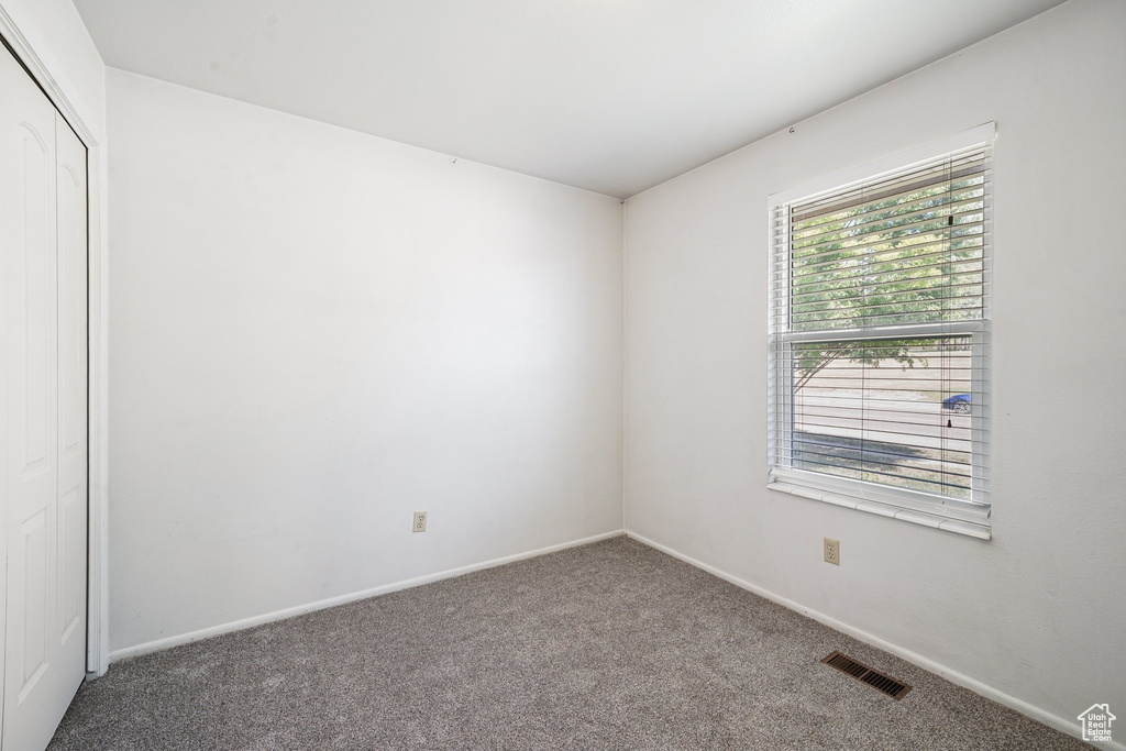 Unfurnished room featuring carpet flooring and baseboards