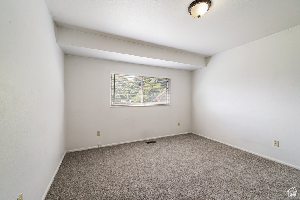 Unfurnished room featuring carpet floors and baseboards