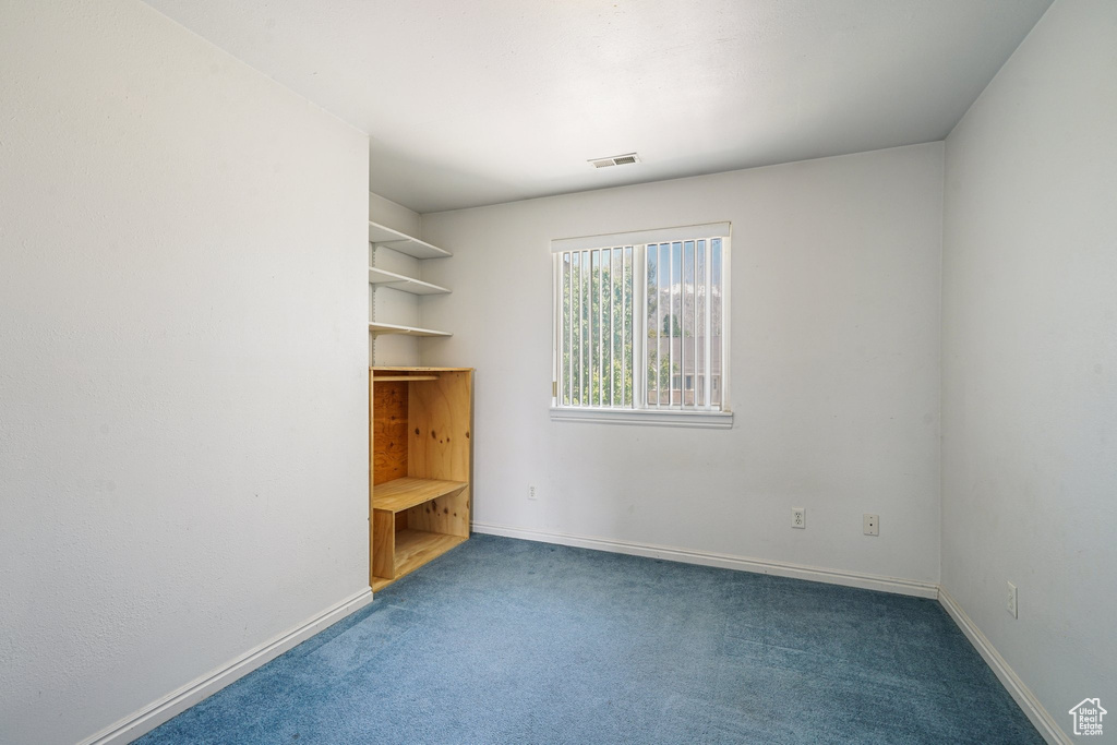Unfurnished bedroom with carpet and baseboards
