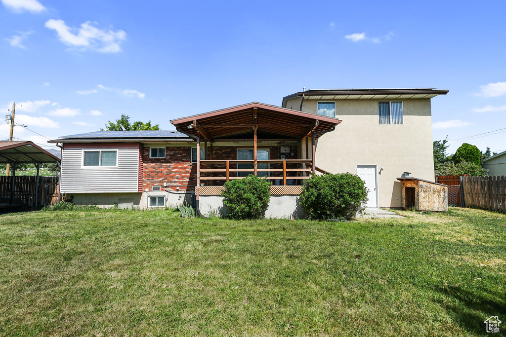 Rear view of property featuring roof mounted solar panels