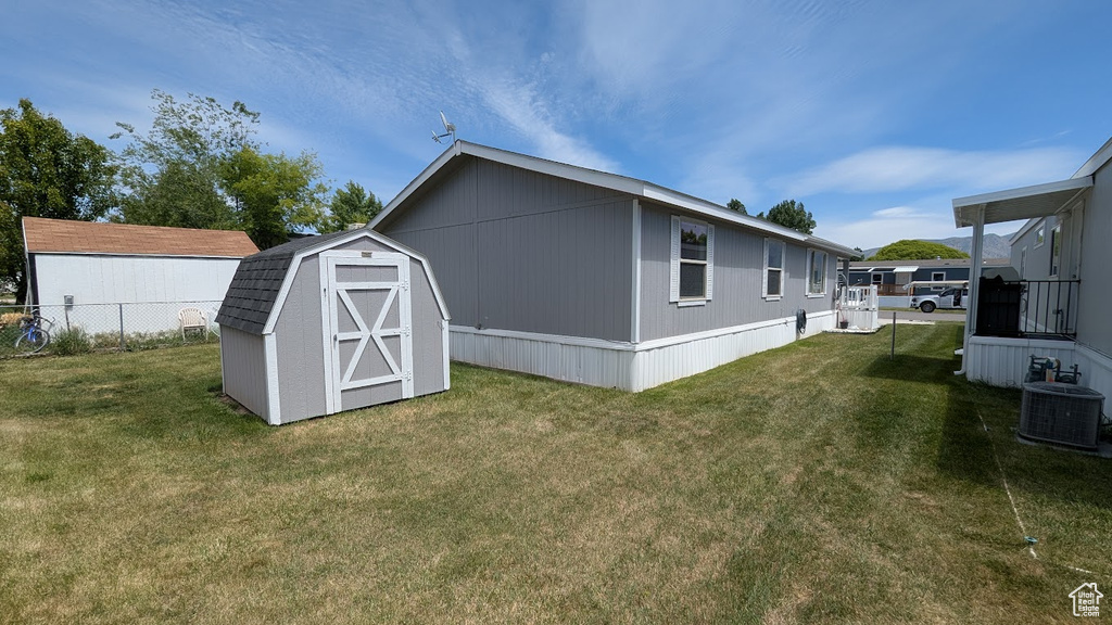 Rear view of property featuring central AC unit