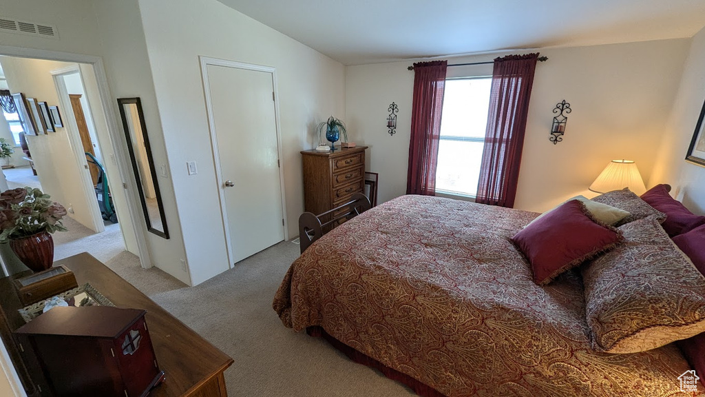 Carpeted bedroom featuring vaulted ceiling