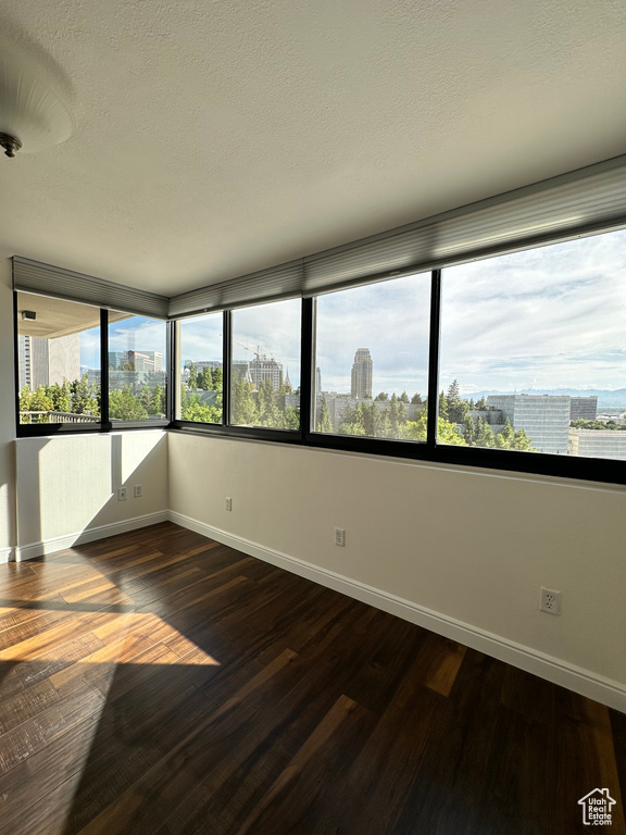 Unfurnished sunroom featuring a city view