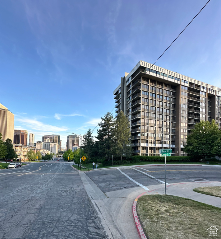 View of building exterior featuring uncovered parking