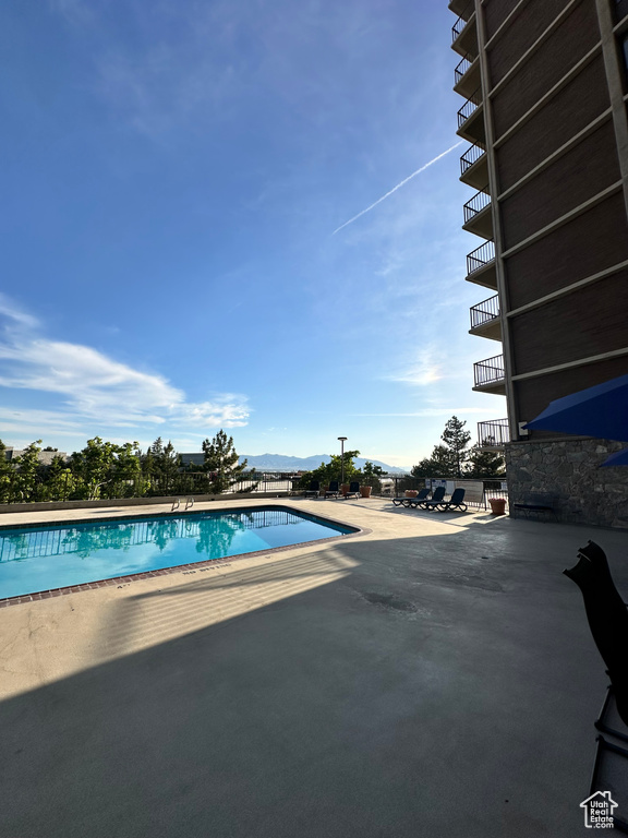 Community pool featuring a patio area and a mountain view