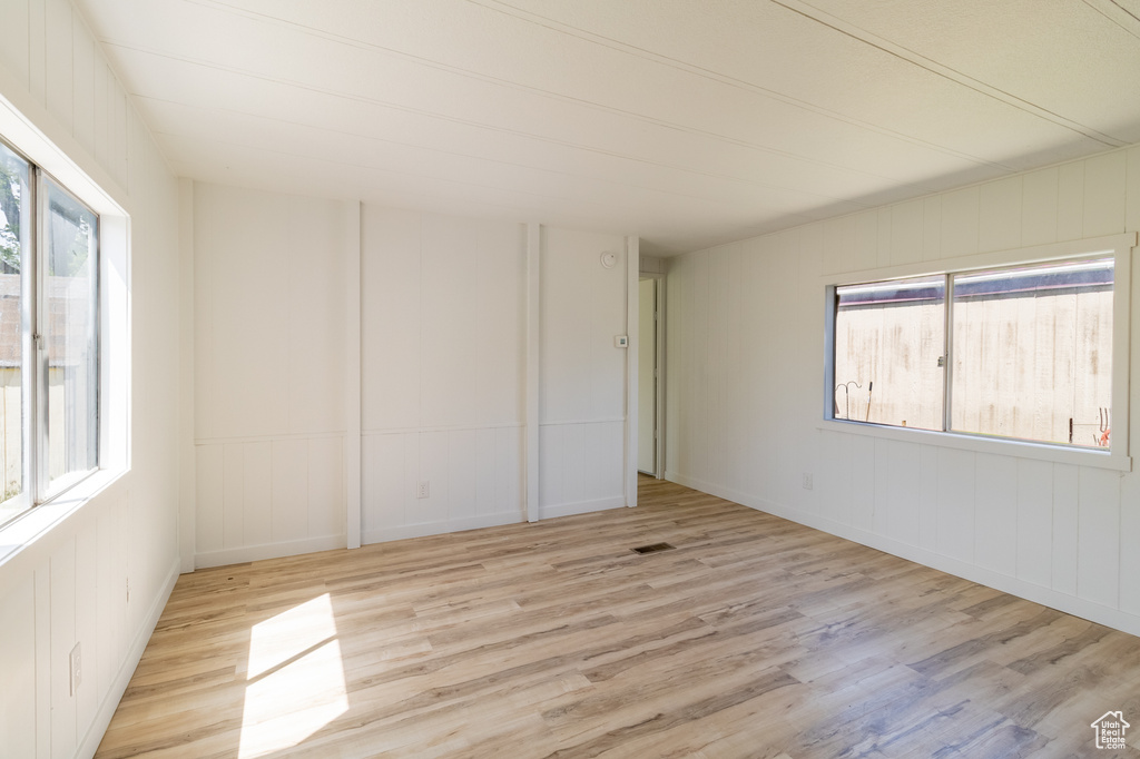 Unfurnished room with wood finished floors and baseboards