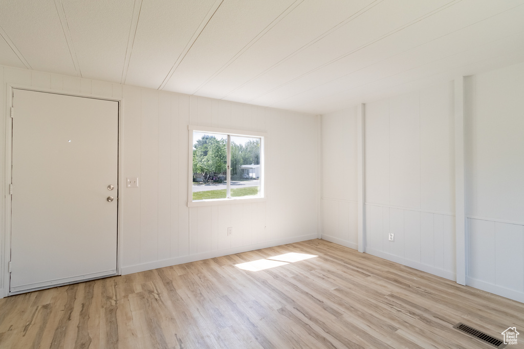 Spare room featuring wood finished floors and baseboards