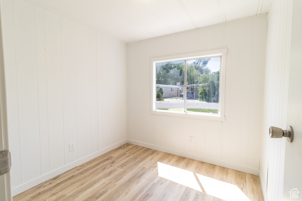 Unfurnished room featuring light wood-style floors and baseboards