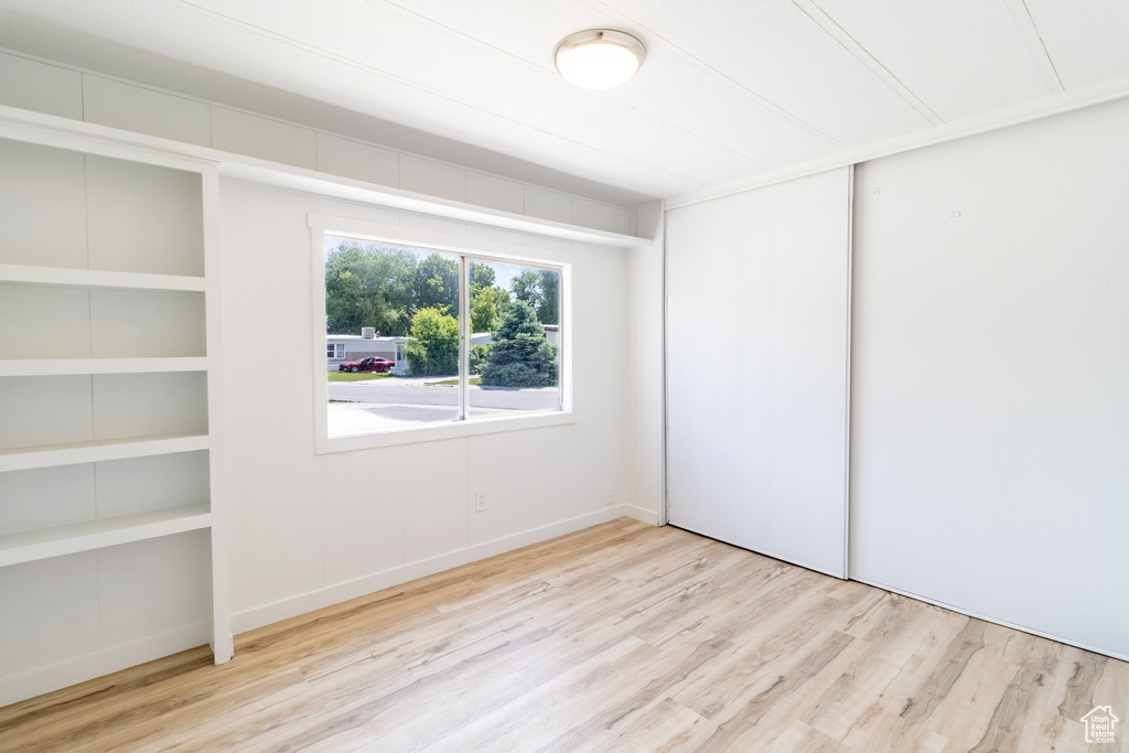 Unfurnished bedroom with wood finished floors