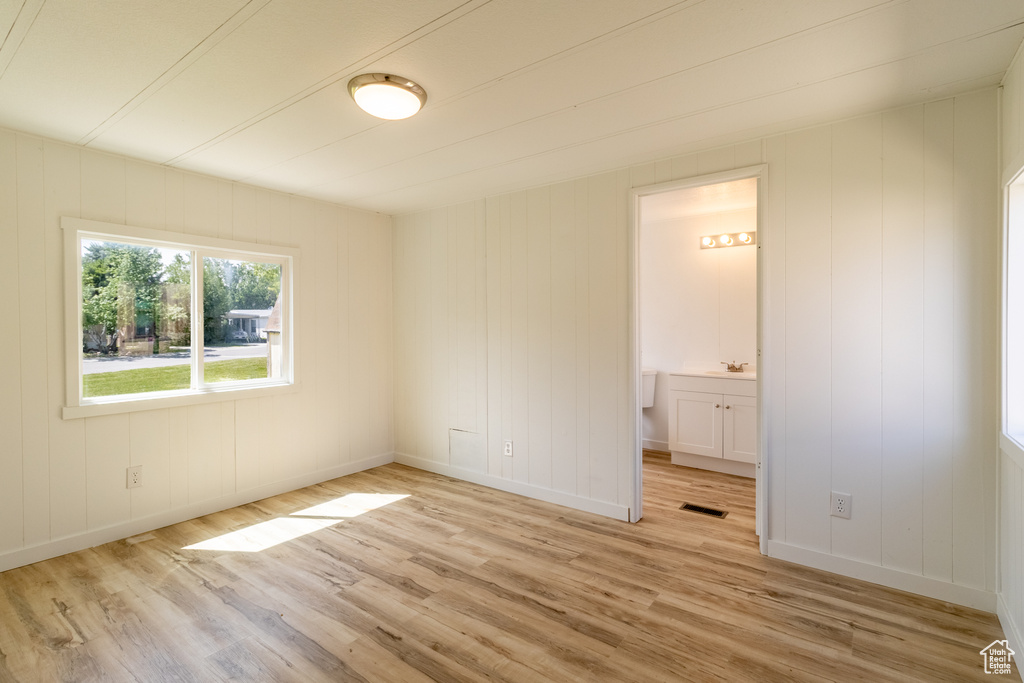 Spare room with light wood-type flooring and baseboards