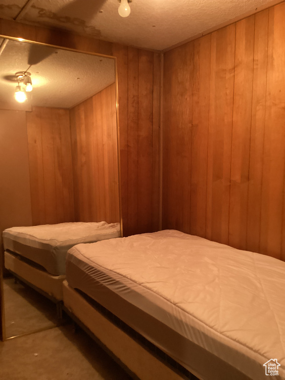 Bedroom featuring wooden walls