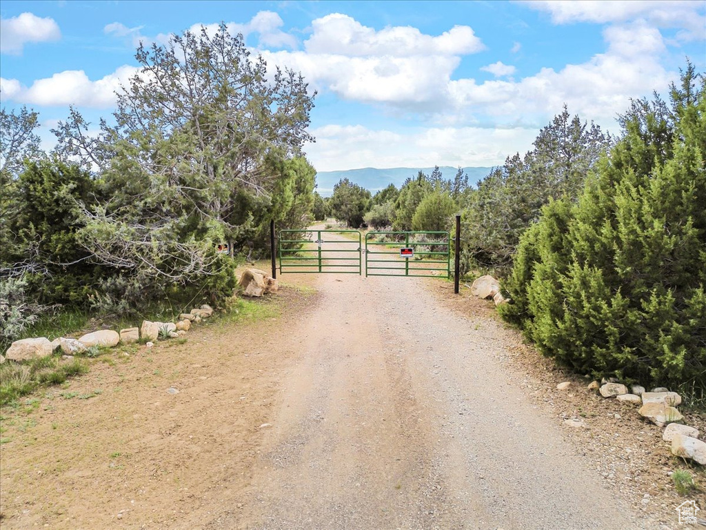 View of road featuring a gate and a rural view