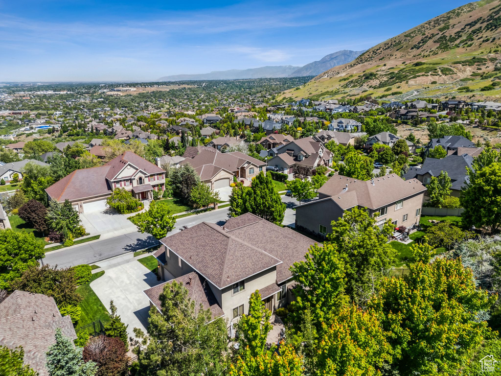 Aerial perspective of suburban area featuring a mountainous background